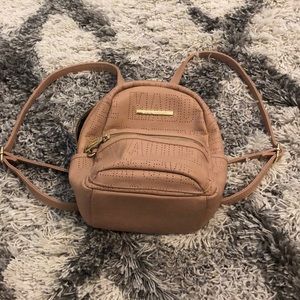 Rose gold Steve Madden mini backpack.